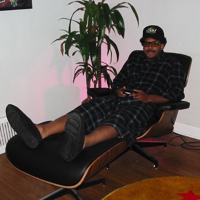 Zack Fox Chilling in a chair holding a PS4 controller.